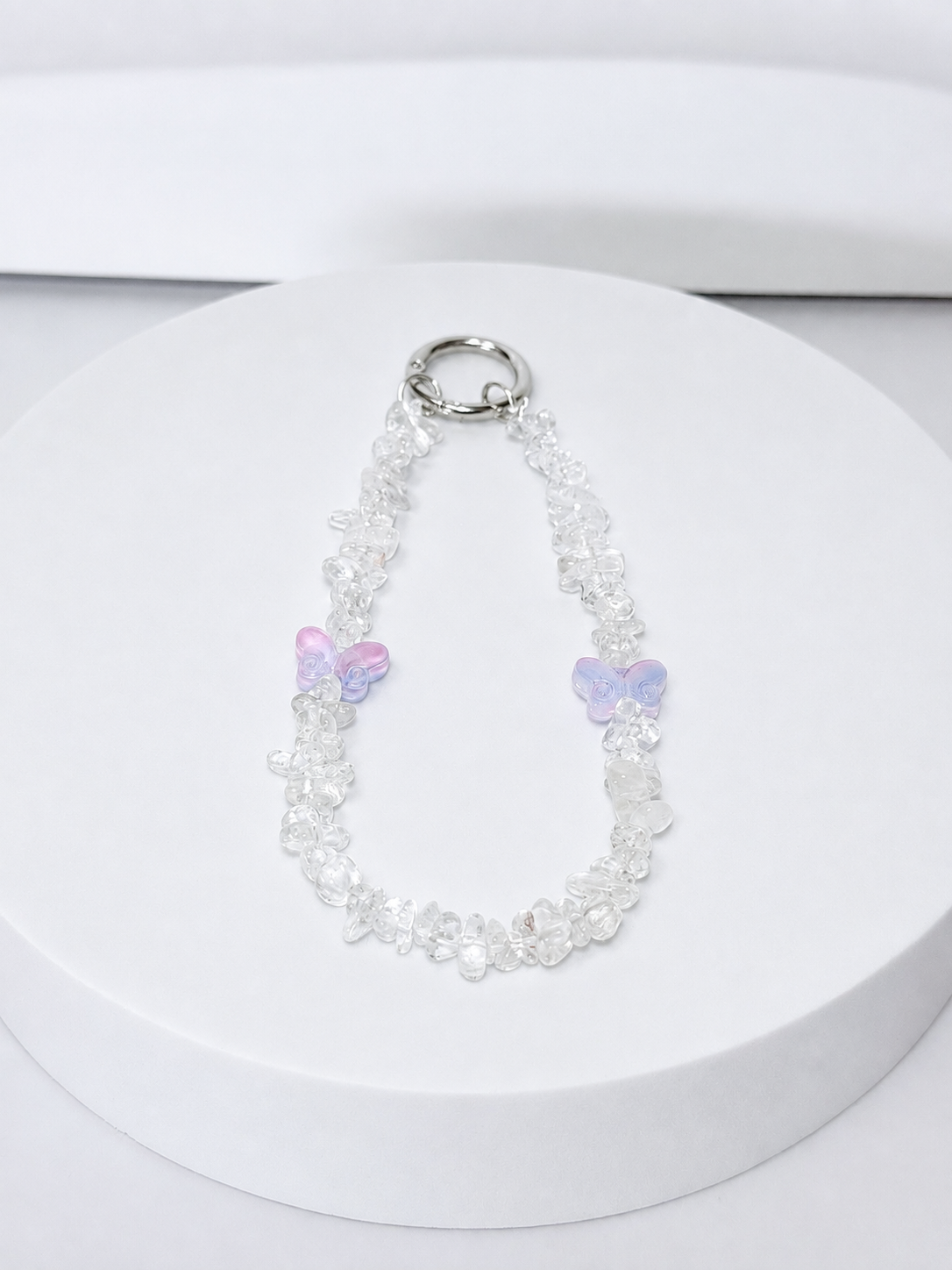 Clear quartz chip phone and bag charm with opalite butterfly accents and silver-tone hardware