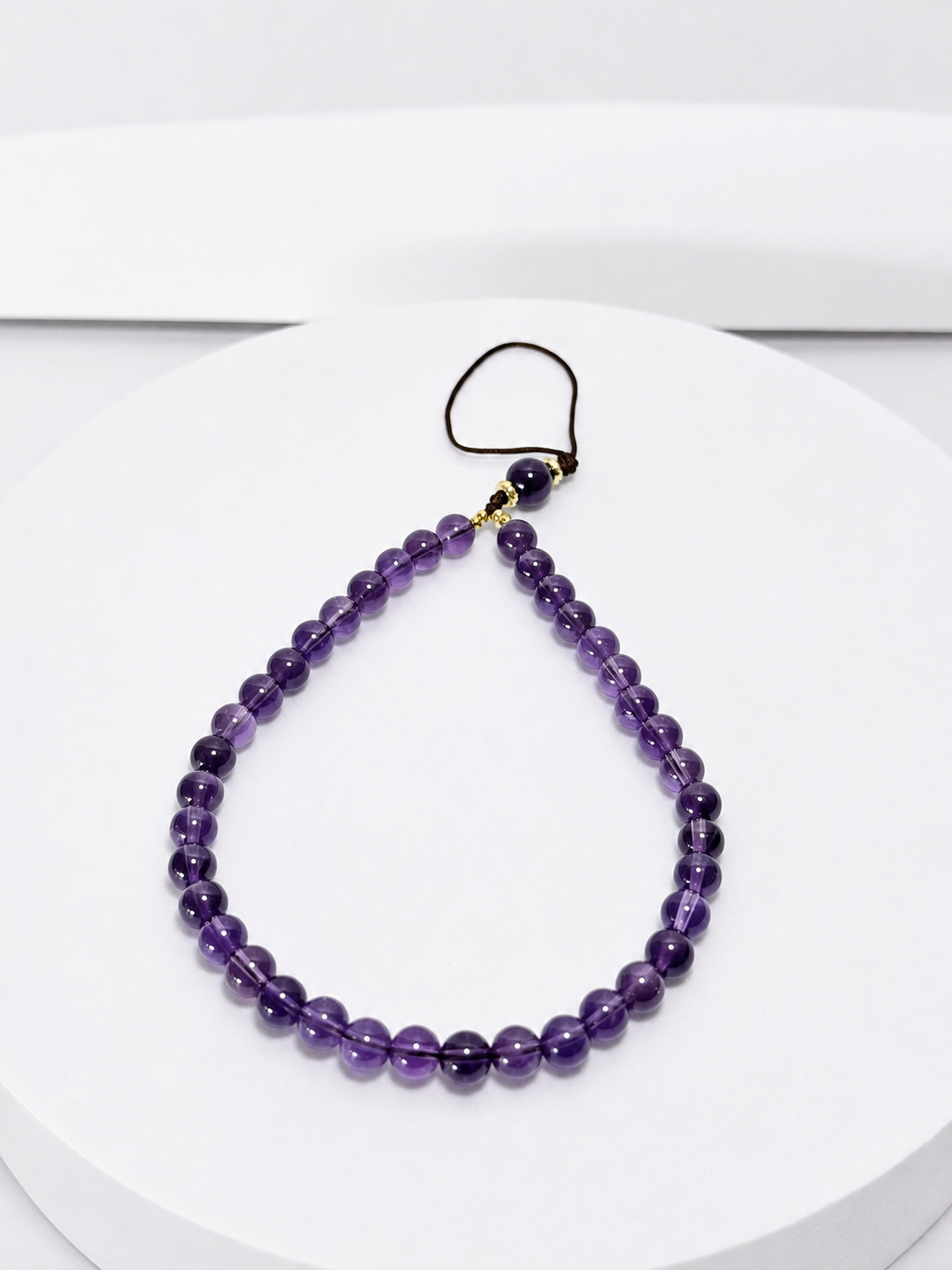Purple amethyst 6mm bead phone and bag charm with gold-tone accents and black attachment loop
