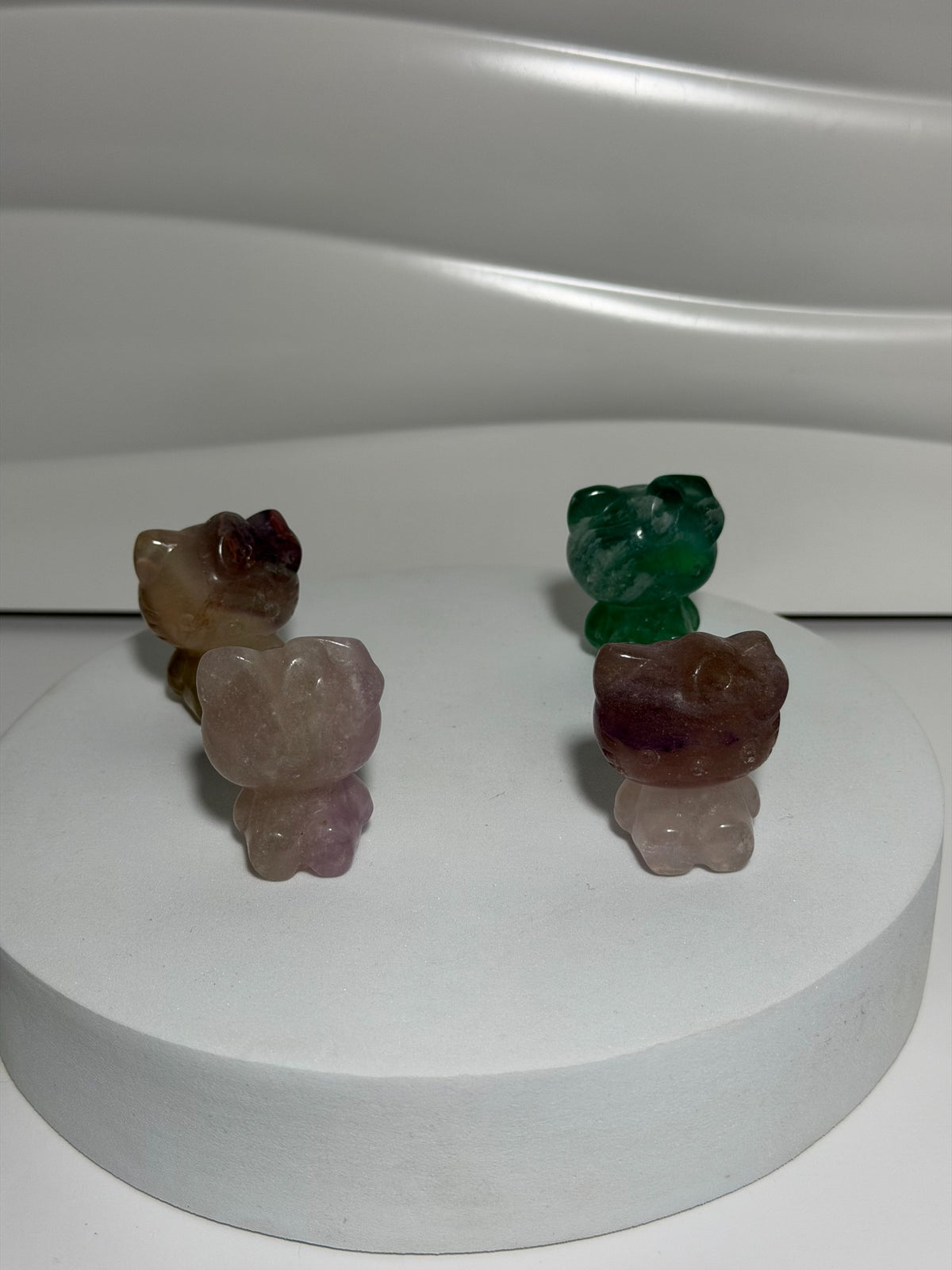 Blue, pink, and purple fluorite Hello Kitty crystal carvings