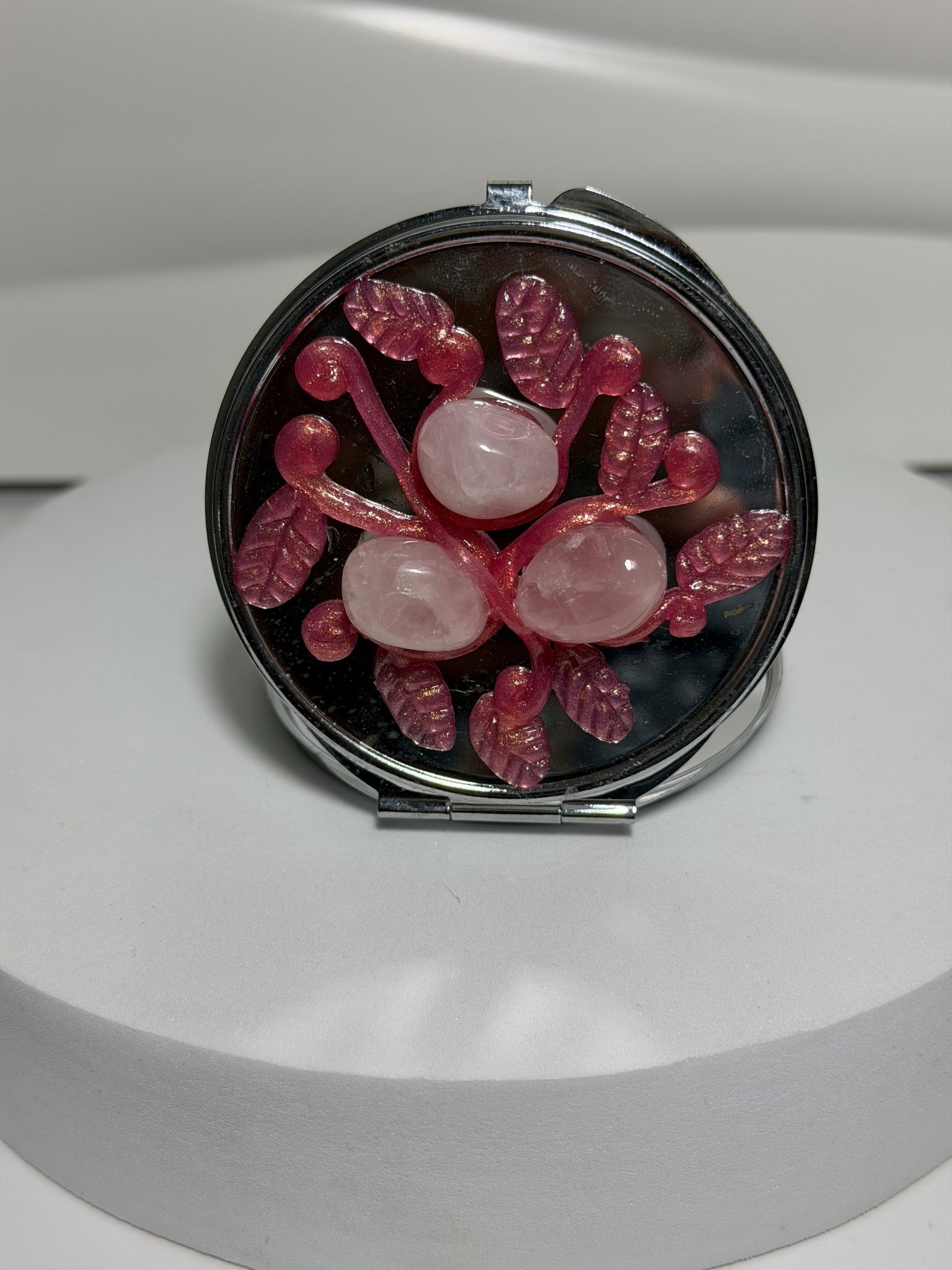 Rose quartz crystal pocket mirror with botanical design