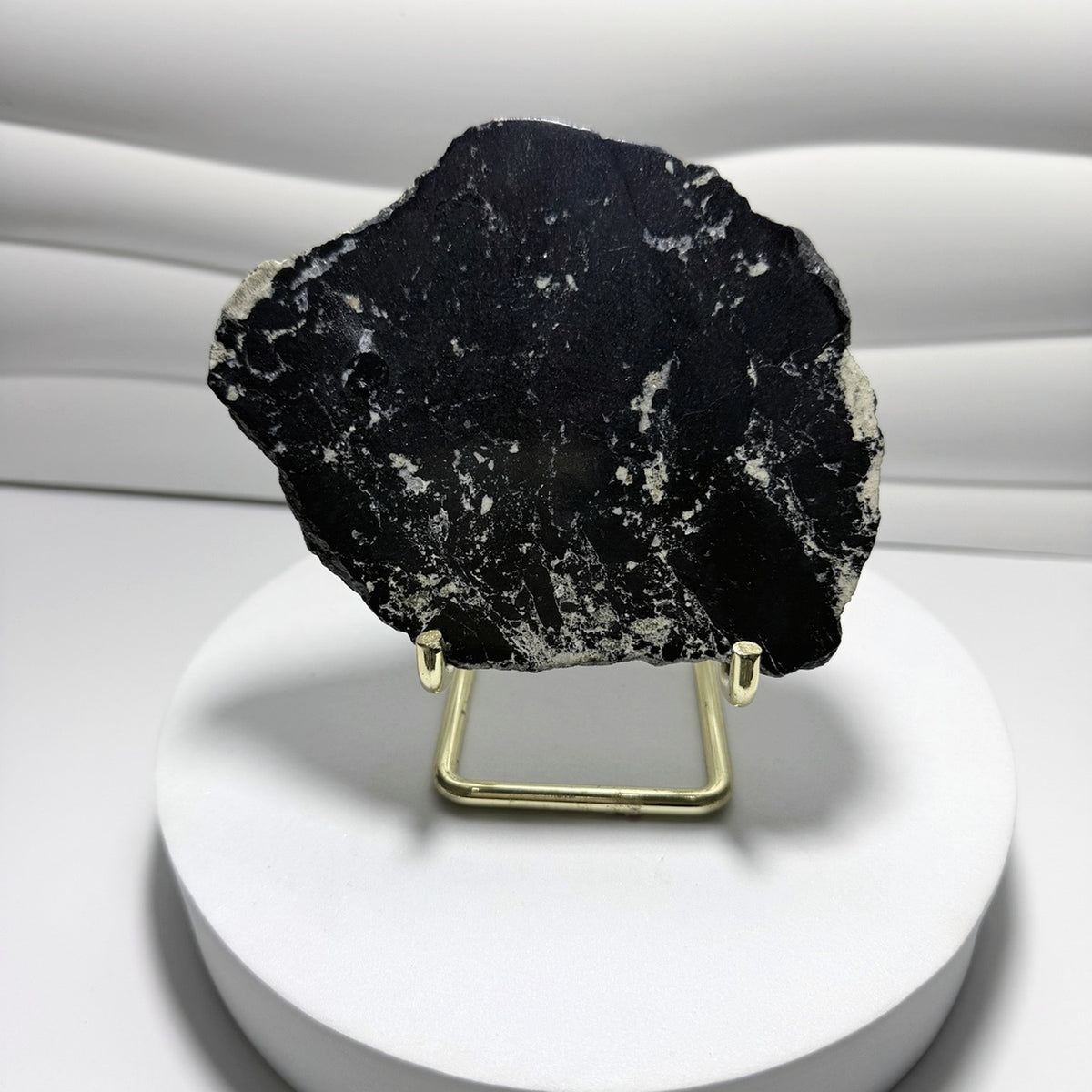 Covellite slab displayed on gold-tone stand