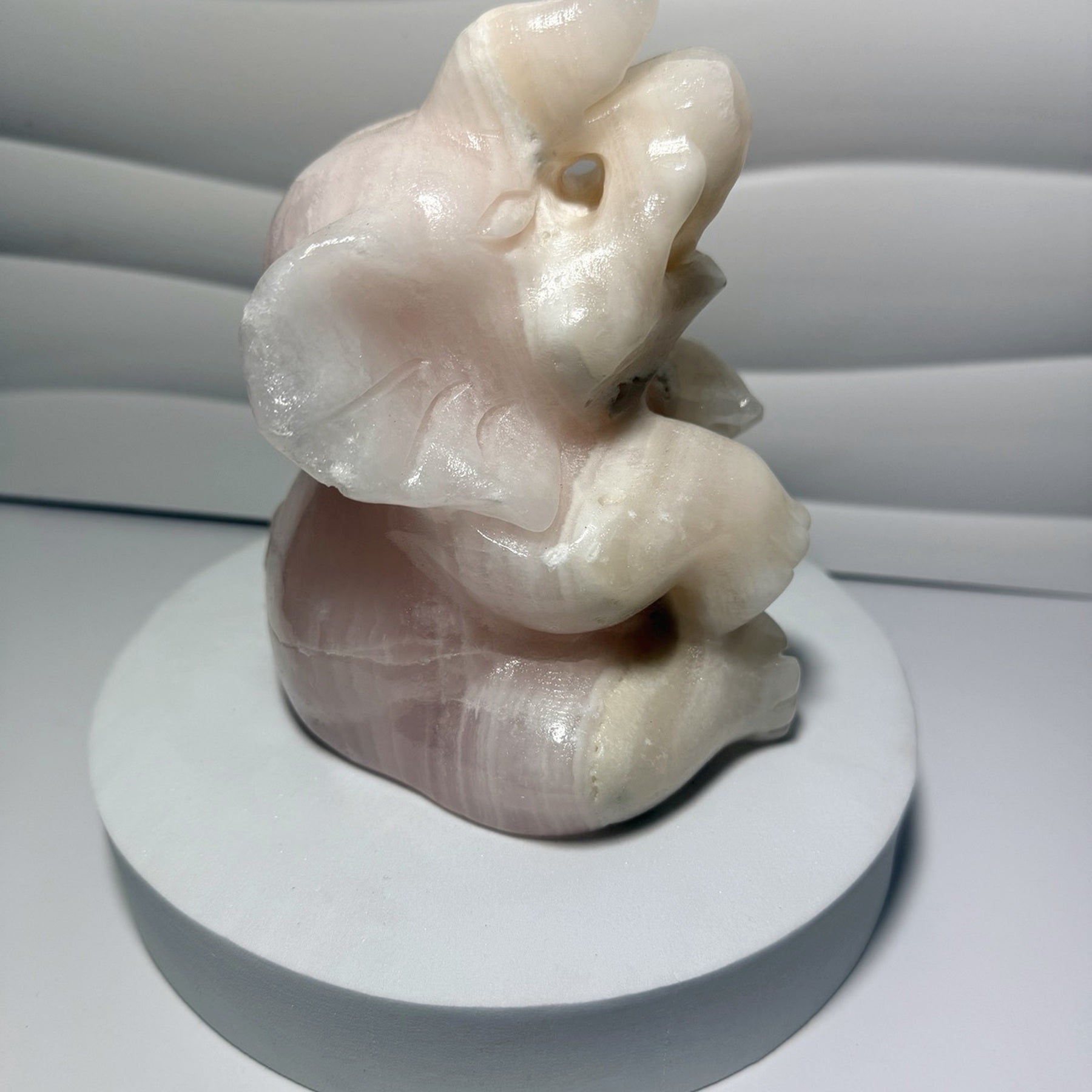 Large pink calcite elephant carving angled view