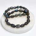 Labradorite nugget stretch bracelet on white stone display