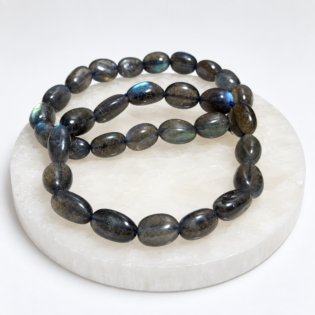 Labradorite nugget stretch bracelet on white stone display