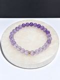 Certified High-Quality Lavender Moon Quartz 5mm stretch bracelet on white stone display