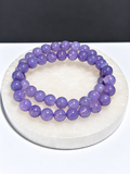 High-Grade Deep Purple Lavender Moon Quartz 7mm stretch bracelet on white stone display