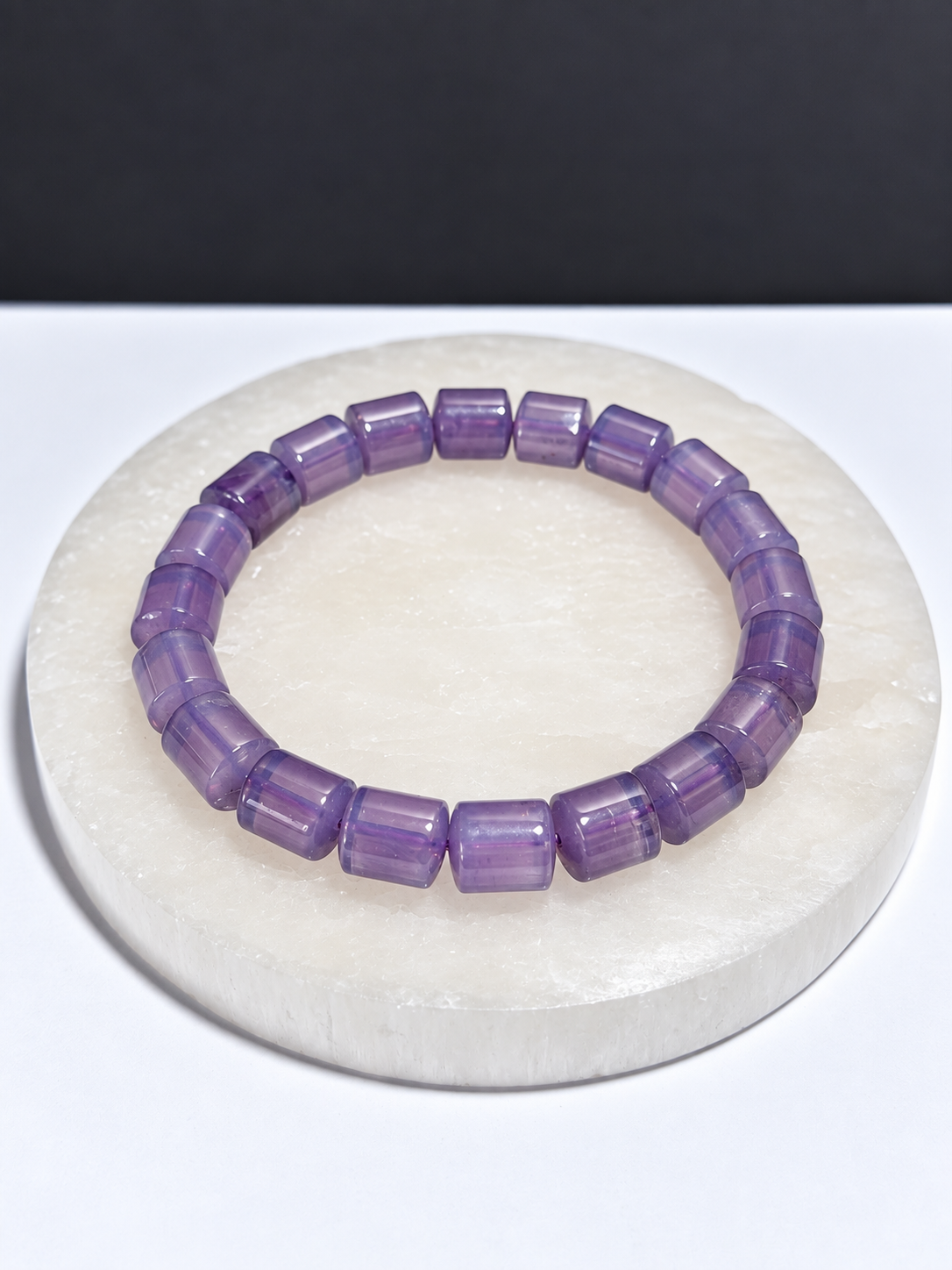 High-grade Lavender Moon Quartz rondelle stretch bracelet on white stone display