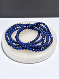 Lapis Lazuli 3mm faceted stretch bracelet on white stone display
