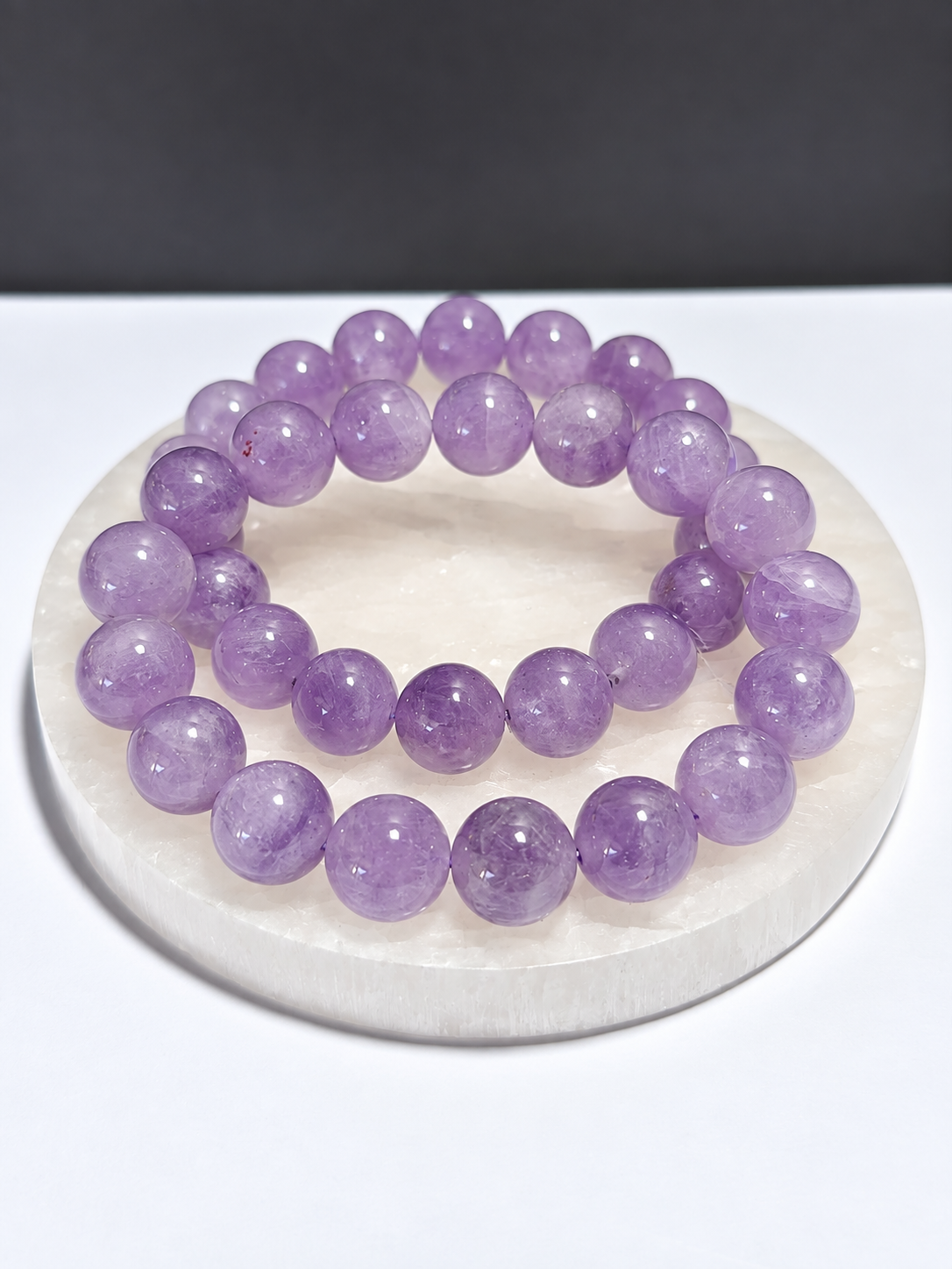 Lavender Amethyst 9mm round stretch bracelet on white stone display