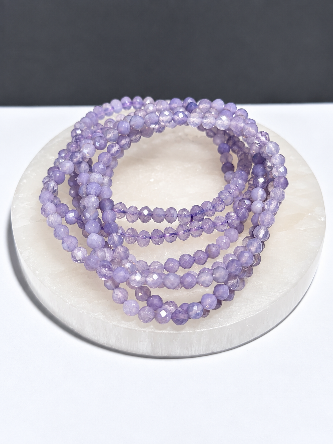 Lavender Moon Quartz 4mm faceted stretch bracelet on white stone display