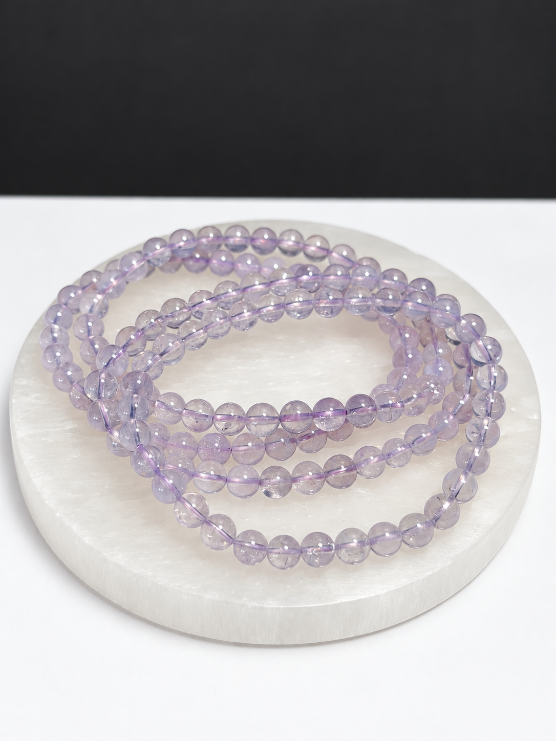 Lavender Moon Quartz 5mm round stretch bracelet on white stone display