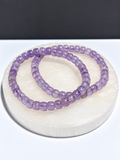 Lavender Moon Quartz rondelle stretch bracelet on white stone display