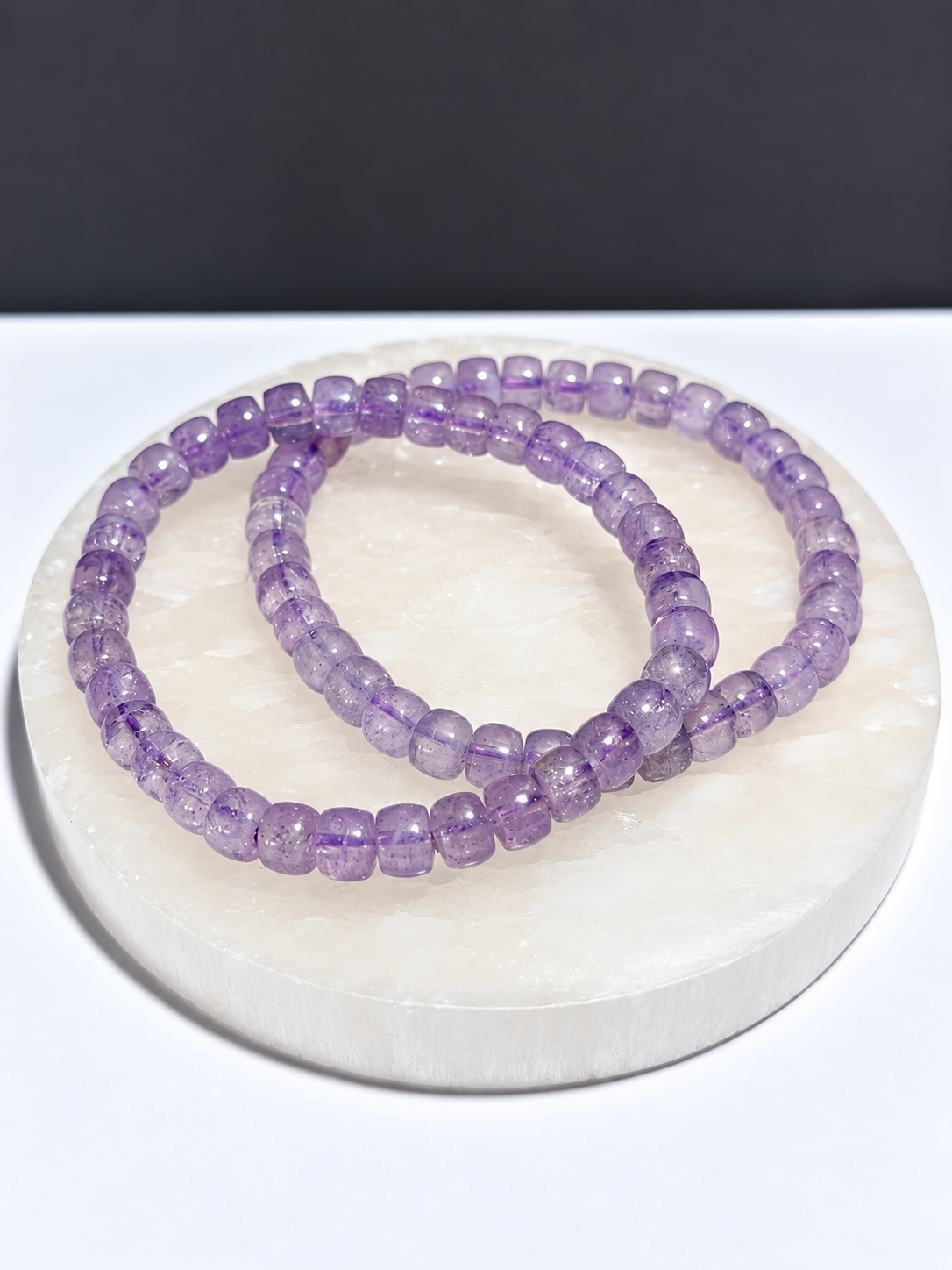Lavender Moon Quartz rondelle stretch bracelet on white stone display