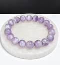 Milky Lavender Moon Quartz 9mm stretch bracelet on white stone display