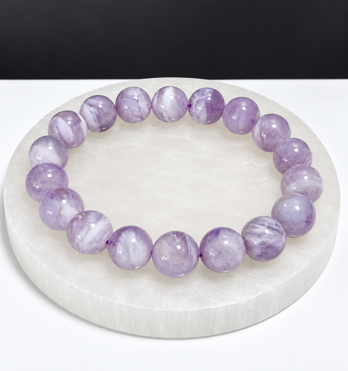 Milky Lavender Moon Quartz 9mm stretch bracelet on white stone display