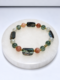 Size 7 stretch bracelet with four abalone beads, four sunstone beads, glass beads, and gold-toned spacers