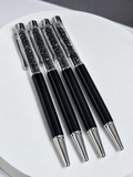 Black and silver pen filled with black obsidian chips