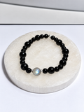 Black Onyx 6-8mm stretch bracelet with 8mm Labradorite center bead and silver accents