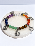 Chakra-inspired 7 mm multistone stretch bracelet with multiple silver-tone chakra charms