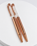 Rose gold pen with clear quartz chip-filled barrel and black ball ink