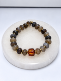 Dyed jade donut bead stretch bracelet with amber focal bead and brass findings