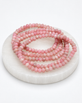 Pink Opal 4mm faceted donut stretch bracelet on white selenite display