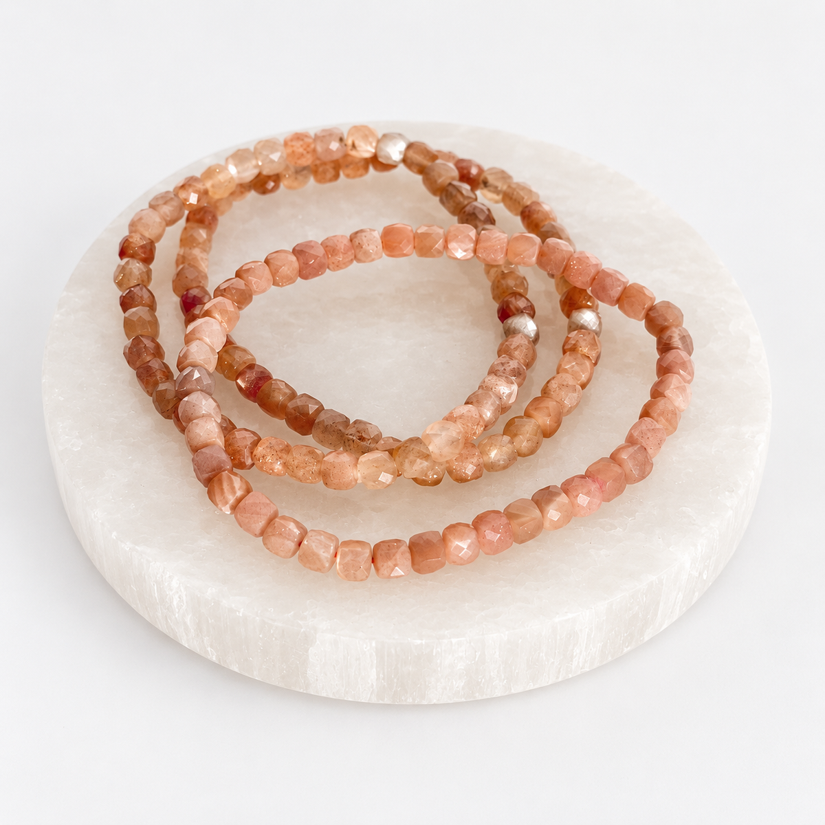 Faceted 4mm Sunstone stretch bracelets in natural peach and apricot tones
