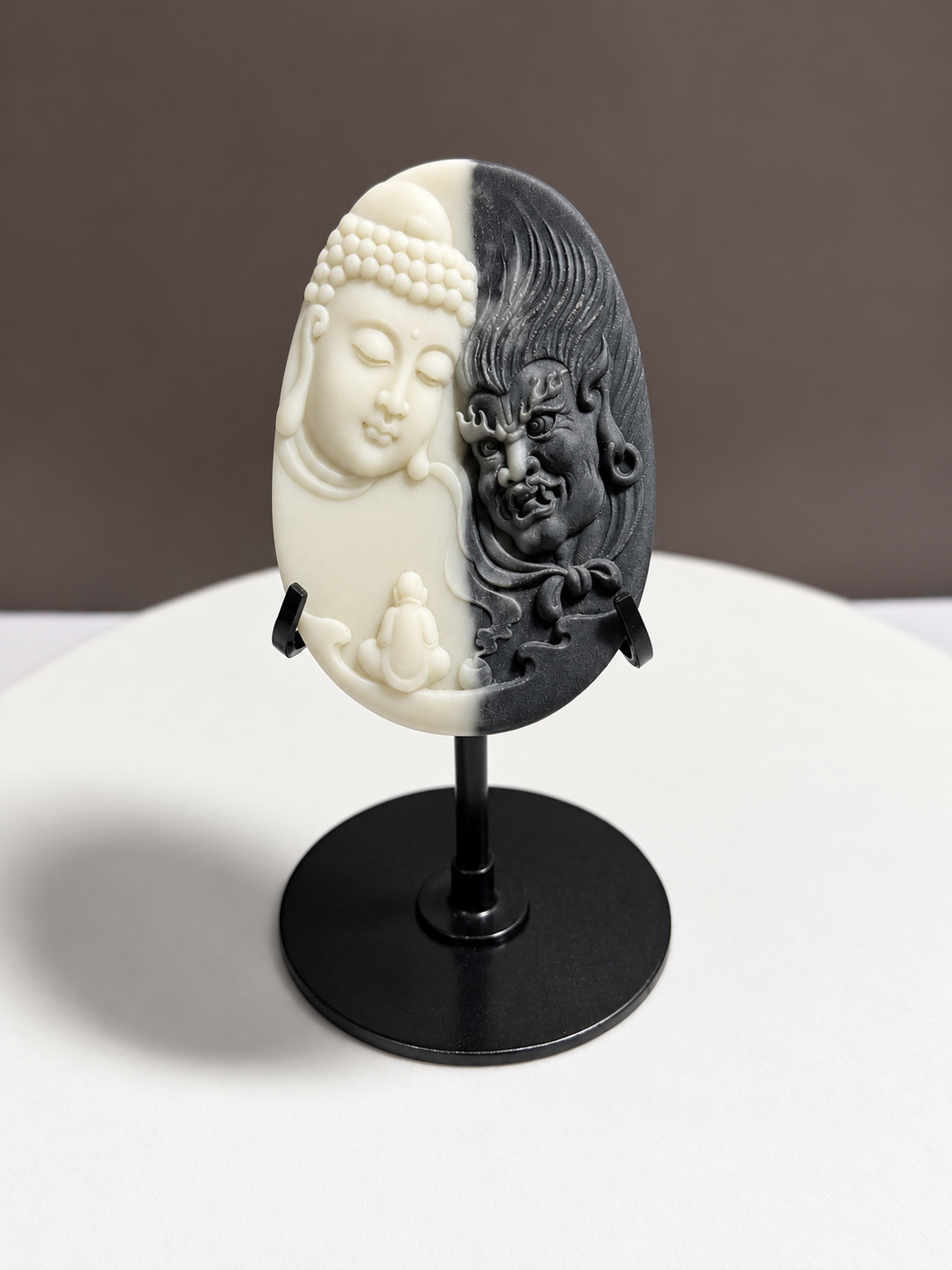 Tai Chi Stone black and white Buddha and guardian relief carving displayed on black stand