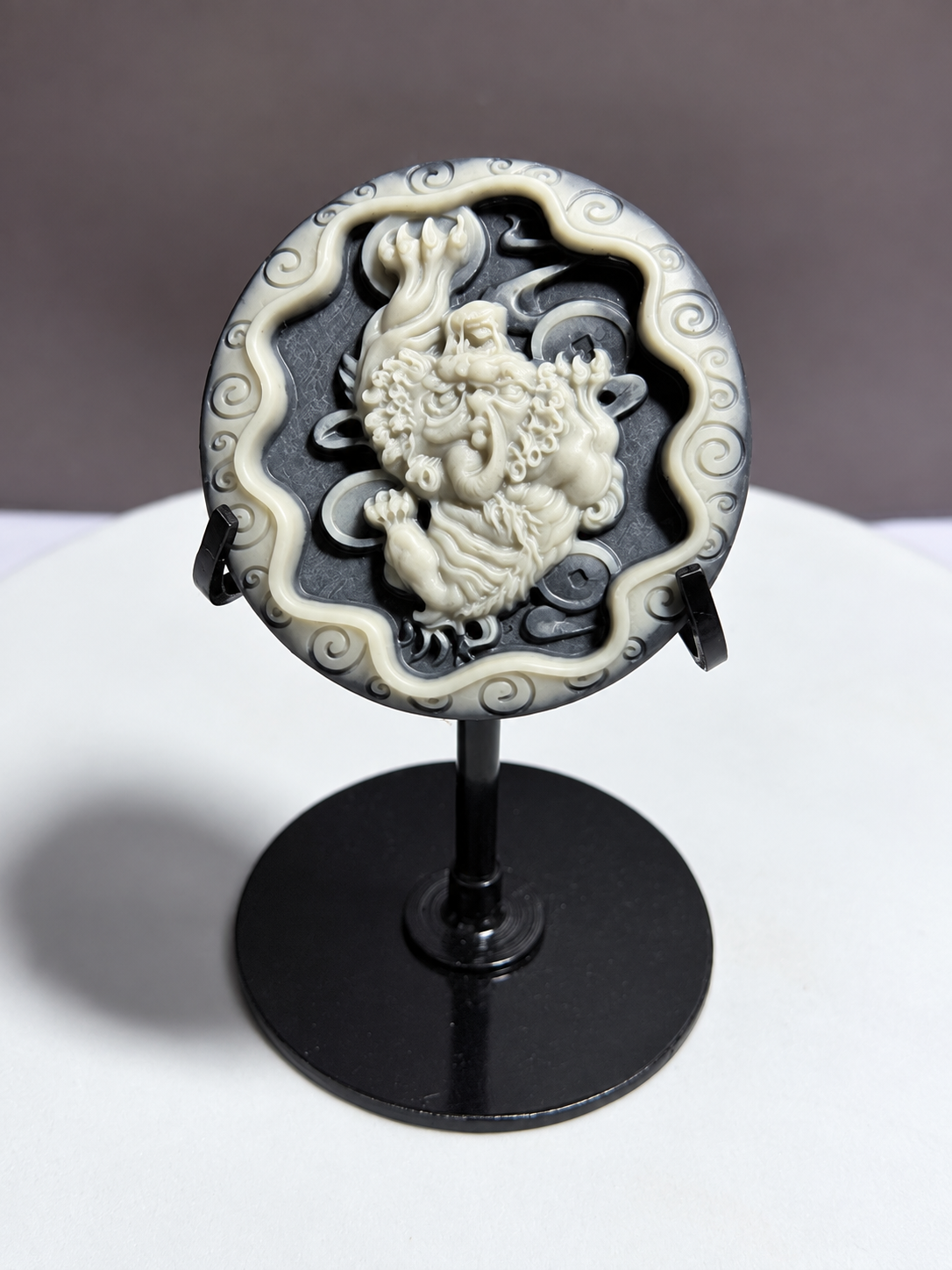Tai Chi Stone circular medallion with guardian lion or Pixiu-style relief carving on black stand
