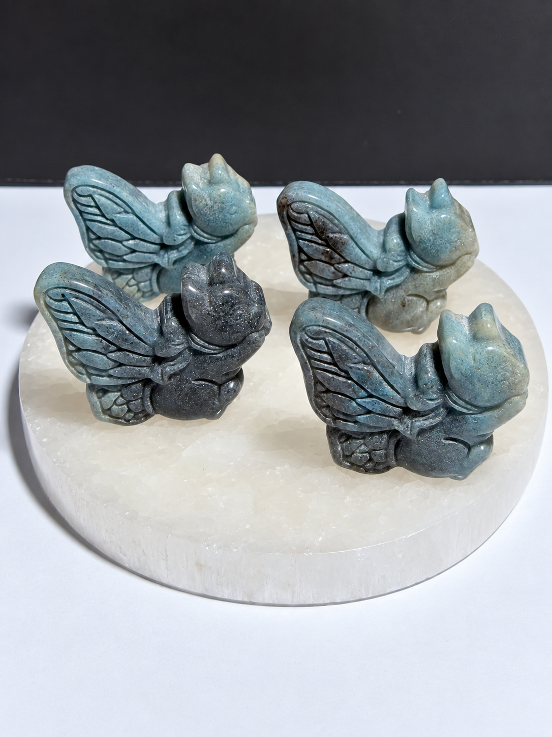 Trollite squirrel carvings on white stone display